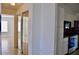 Hallway view showcases tile flooring and seamless access to the kitchen at 21332 Walling Ct, Port Charlotte, FL 33954