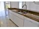 Kitchen sink with granite counters and white cabinetry at 21332 Walling Ct, Port Charlotte, FL 33954