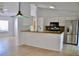 Kitchen with stainless steel appliances, light countertops, white cabinetry, and breakfast bar at 21332 Walling Ct, Port Charlotte, FL 33954