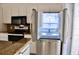 Kitchen featuring stainless steel refrigerator with interior view and granite counters at 21332 Walling Ct, Port Charlotte, FL 33954