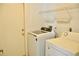 Washer and dryer inside of a laundry room with a door at 21332 Walling Ct, Port Charlotte, FL 33954