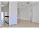 Open-concept living room with light tile flooring, neutral walls, and a view into the adjacent kitchen at 21332 Walling Ct, Port Charlotte, FL 33954