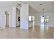 Bright and airy living room featuring neutral tile floors, ceiling fan, and modern lighting fixture at 21332 Walling Ct, Port Charlotte, FL 33954