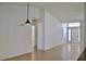 Bright living area with modern pendant lighting, light tile flooring, and seamless transition to other spaces at 21332 Walling Ct, Port Charlotte, FL 33954