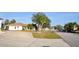 A neighborhood view shows a street with homes, landscaping, and parked cars at 21332 Walling Ct, Port Charlotte, FL 33954