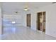 Bright sunroom with white tile flooring, sliding glass doors, and two ceiling fans at 21332 Walling Ct, Port Charlotte, FL 33954