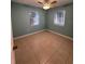 Serene bedroom with two windows, neutral walls, and tile flooring at 22095 Lasalle Rd, Port Charlotte, FL 33952