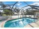 Relaxing pool area enclosed with screen, perfect for swimming and enjoying outdoors at 22285 Walton Ave, Port Charlotte, FL 33952