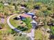 Aerial view of the property showcasing the home, screened lanai and the surrounding landscape at 24485 Tangerine Ave, Punta Gorda, FL 33980