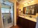 Charming bathroom with beautiful wood cabinets and a connecting door to a second bathroom at 24485 Tangerine Ave, Punta Gorda, FL 33980