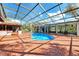 Inviting in-ground screened pool with brick surround, ideal for relaxation and outdoor fun at 24485 Tangerine Ave, Punta Gorda, FL 33980