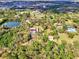 Aerial view of the outlined property featuring a house, a private pond, and tree lined driveway at 24485 Tangerine Ave, Punta Gorda, FL 33980