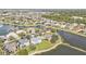 Panoramic aerial view showcasing a lakeside neighborhood with beautifully landscaped lawns, mature trees, and well-kept homes at 24528 Sunrise Dr, Punta Gorda, FL 33980