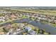 Picturesque aerial view of a waterfront community showcasing well-maintained homes surrounding a serene lake with mature trees at 24528 Sunrise Dr, Punta Gorda, FL 33980