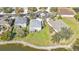 Expansive aerial view of a well-maintained home with a lush green lawn and serene lakefront property at 24528 Sunrise Dr, Punta Gorda, FL 33980