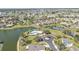 Wonderful aerial view of a community with a lake, pool, lush landscaping, and many beautiful homes at 24528 Sunrise Dr, Punta Gorda, FL 33980
