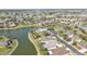 Breathtaking aerial shot of a community with a lake, pool, lush landscaping, and many beautiful homes at 24528 Sunrise Dr, Punta Gorda, FL 33980