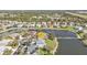 Aerial view of a lakeside home showing lush landscaping and access to neighborhood water feature at 24528 Sunrise Dr, Punta Gorda, FL 33980