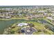 Gorgeous aerial view of a community with a lake, pool, lush landscaping, and many beautiful homes at 24528 Sunrise Dr, Punta Gorda, FL 33980