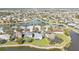Scenic aerial view of a tranquil lakeside community with manicured lawns, towering trees, and beautifully maintained residences at 24528 Sunrise Dr, Punta Gorda, FL 33980