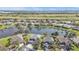 A beautiful aerial view of lakeside homes in a lush community with manicured lawns and mature trees on a sunny day at 24528 Sunrise Dr, Punta Gorda, FL 33980