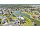 Incredible aerial view of a community with a lake, pool, lush landscaping, and many beautiful homes at 24528 Sunrise Dr, Punta Gorda, FL 33980