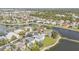 Expansive aerial shot of a tranquil lakeside community with lush trees and manicured lawns surrounding well-maintained homes at 24528 Sunrise Dr, Punta Gorda, FL 33980