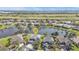 Aerial view of the home showing the lake view, surrounding neighborhood and lush green landscape at 24528 Sunrise Dr, Punta Gorda, FL 33980