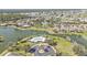 Amazing aerial view of a community with a lake, pool, lush landscaping, and many beautiful homes at 24528 Sunrise Dr, Punta Gorda, FL 33980