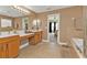 Spacious bathroom features a double vanity, large mirror, tile flooring and soaking tub at 24528 Sunrise Dr, Punta Gorda, FL 33980
