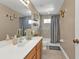 Well-lit bathroom with a single sink vanity, mirrored cabinet, and shower/tub combination at 24528 Sunrise Dr, Punta Gorda, FL 33980