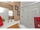 Bright bathroom with a glass-enclosed shower, white vanity, and natural light at 24528 Sunrise Dr, Punta Gorda, FL 33980