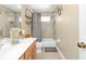 Stylish bathroom featuring a single sink vanity, shower/tub combination, and modern fixtures at 24528 Sunrise Dr, Punta Gorda, FL 33980