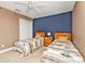 Cozy bedroom featuring two twin beds, a ceiling fan, and neutral decor, perfect for guests or children at 24528 Sunrise Dr, Punta Gorda, FL 33980