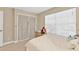 Bright bedroom featuring a comfortable bed and a large window that provides ample natural light at 24528 Sunrise Dr, Punta Gorda, FL 33980