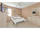 Comfortable bedroom featuring neutral decor, ceiling fan, and ample natural light at 24528 Sunrise Dr, Punta Gorda, FL 33980