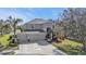 Two-story home featuring an attached three-car garage and covered front entryway at 24528 Sunrise Dr, Punta Gorda, FL 33980