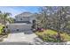 Two-story home featuring an attached three-car garage and covered front entryway at 24528 Sunrise Dr, Punta Gorda, FL 33980