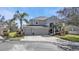 Two-story home featuring an attached three-car garage and covered front entryway at 24528 Sunrise Dr, Punta Gorda, FL 33980