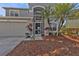 Charming home entrance with a two-car garage, a well-manicured garden, and a welcoming front door at 24528 Sunrise Dr, Punta Gorda, FL 33980