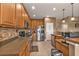 Well-lit kitchen featuring wooden cabinets, stainless steel appliances, and a tile backsplash at 24528 Sunrise Dr, Punta Gorda, FL 33980