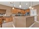 Well-equipped kitchen featuring wooden cabinets, stainless steel appliances, and a breakfast bar at 24528 Sunrise Dr, Punta Gorda, FL 33980