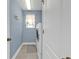 Well-lit laundry room with a modern washer and dryer, and blue walls adding a touch of style at 24528 Sunrise Dr, Punta Gorda, FL 33980