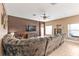 Spacious living room featuring tile flooring, a ceiling fan, and a comfortable sectional sofa at 24528 Sunrise Dr, Punta Gorda, FL 33980