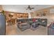 Open concept living room with tile flooring, a comfortable sectional sofa, and an adjacent dining area at 24528 Sunrise Dr, Punta Gorda, FL 33980