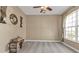 Large room with neutral carpet, a large window for natural light and ceiling fan at 24528 Sunrise Dr, Punta Gorda, FL 33980
