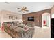 Spacious living room featuring tile flooring, a ceiling fan, and a comfortable sectional sofa at 24528 Sunrise Dr, Punta Gorda, FL 33980