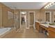 Beautiful main bathroom featuring a walk-in shower, soaking tub, double sinks, and walk-in closet at 24528 Sunrise Dr, Punta Gorda, FL 33980