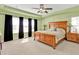 Spacious main bedroom with a large bed, ceiling fan, and ample natural light at 24528 Sunrise Dr, Punta Gorda, FL 33980