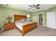 Lovely main bedroom with a large bed, matching nightstands, and a view to the bathroom at 24528 Sunrise Dr, Punta Gorda, FL 33980